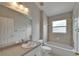 Bright bathroom featuring a bathtub, shower with glass door, and large vanity with a mirror at 6801 Bishops Pointe Way, Riverview, FL 33578