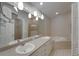 Modern bathroom with double sinks, jacuzzi tub, walk-in shower, and pendant lighting at 6801 Bishops Pointe Way, Riverview, FL 33578