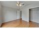 Bedroom features hardwood floors, ceiling fan and closet in a neutral color scheme at 6801 Bishops Pointe Way, Riverview, FL 33578
