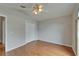 Bedroom features hardwood floor, ceiling fan, and a closet with a double door at 6801 Bishops Pointe Way, Riverview, FL 33578