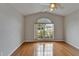 Bright bedroom boasts wood flooring and a large window offering views of the neighborhood at 6801 Bishops Pointe Way, Riverview, FL 33578