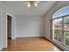 Bedroom features wood floor, large window for natural light, and a closet with an opened white door at 6801 Bishops Pointe Way, Riverview, FL 33578