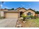 Inviting single-story home featuring a lush front yard, brick accents, and a two-car garage at 6801 Bishops Pointe Way, Riverview, FL 33578
