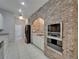 A kitchen with white cabinets, stainless steel appliances, and a brick oven at 6801 Bishops Pointe Way, Riverview, FL 33578