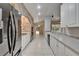Spacious kitchen boasts white cabinets, stainless steel appliances, and a brick oven at 6801 Bishops Pointe Way, Riverview, FL 33578