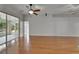 Spacious living room featuring hardwood flooring and sliding glass doors to the patio at 6801 Bishops Pointe Way, Riverview, FL 33578