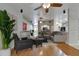 Bright and airy living room featuring hardwood floors, ceiling fans, and views of the entryway at 6801 Bishops Pointe Way, Riverview, FL 33578