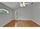 The main bedroom includes wood floor, ceiling fan and an open door to the bathroom at 6801 Bishops Pointe Way, Riverview, FL 33578