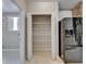 Walk-in pantry with white shelving offers ample storage space in the kitchen at 6801 Bishops Pointe Way, Riverview, FL 33578