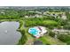 Community pool by a serene lake, perfect for relaxing and enjoying the outdoors at 6801 Bishops Pointe Way, Riverview, FL 33578