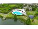 Community pool and pond amidst lush landscaping, creating a resort-like atmosphere at 6801 Bishops Pointe Way, Riverview, FL 33578