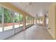 Spacious sunroom with tile floors and multiple windows overlooking the backyard at 6801 Bishops Pointe Way, Riverview, FL 33578
