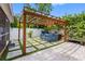 Beautiful backyard features a hot tub, pergola, and a combination of green turf and stone at 8307 Boxwood Dr, Tampa, FL 33615