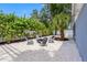 Cozy backyard area offers relaxed seating around a fire pit, surrounded by well-maintained landscaping at 8307 Boxwood Dr, Tampa, FL 33615