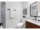 This bathroom features a modern vanity, black hardware, and shower with beautiful marble-style tile at 8307 Boxwood Dr, Tampa, FL 33615