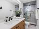 This bathroom includes a modern sink, a wood vanity, and a glass-door shower at 8307 Boxwood Dr, Tampa, FL 33615