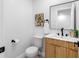 Stylish half bathroom featuring modern vanity with wood grain and black hardware at 8307 Boxwood Dr, Tampa, FL 33615