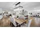 Dining room with wood table, upholstered chairs, and modern light fixture is adjacent to kitchen at 8307 Boxwood Dr, Tampa, FL 33615