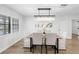 Dining room with wood table, upholstered chairs, and modern light fixture at 8307 Boxwood Dr, Tampa, FL 33615