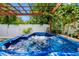 Inviting backyard hot tub with a pergola provides a luxurious retreat with a lush, tropical landscape at 8307 Boxwood Dr, Tampa, FL 33615