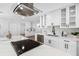 Renovated kitchen boasts white cabinets, stone backsplash, and stainless steel appliances at 8307 Boxwood Dr, Tampa, FL 33615