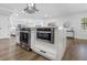 Island offers integrated oven and microwave and white cabinets in an open floorplan kitchen at 8307 Boxwood Dr, Tampa, FL 33615