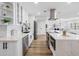 Modern kitchen features white cabinets, stainless steel appliances, and a spacious island with quartz countertops at 8307 Boxwood Dr, Tampa, FL 33615