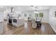 Spacious kitchen and dining room combo with hardwood floors, stainless appliances, and bright modern fixtures at 8307 Boxwood Dr, Tampa, FL 33615