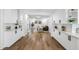 Open living space with white cabinets, hardwood floors, and contemporary decor at 8307 Boxwood Dr, Tampa, FL 33615