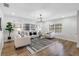 Living room featuring wood floors, a large rug, and comfortable seating at 8307 Boxwood Dr, Tampa, FL 33615