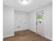 Versatile room with hardwood floors and a door leading to the outside at 8307 Boxwood Dr, Tampa, FL 33615
