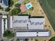 An aerial view showcasing the building's layout, parking, and proximity to the waterfront at 100 Oakmont Ln # 305, Belleair, FL 33756