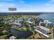 Scenic aerial view of condos near Belleair Country Club with a tranquil lake and lush greenery at 100 Oakmont Ln # 305, Belleair, FL 33756