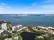 Panoramic aerial view of a waterfront condo with bay views and lush landscaping and pool in Sarasota, Florida at 100 Oakmont Ln # 305, Belleair, FL 33756