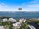 Aerial view of the neighborhood with its waterfront location, showing the homes, lake, and surrounding community at 100 Oakmont Ln # 305, Belleair, FL 33756