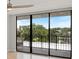 This condo features a delightful balcony with black metal railings overlooking a scenic, tree-lined lake at 100 Oakmont Ln # 305, Belleair, FL 33756