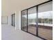 Spacious balcony with expansive sliding glass doors and views of the lush green landscape at 100 Oakmont Ln # 305, Belleair, FL 33756