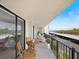 Relaxing balcony space features a small table, seating area, and beautiful views of the surrounding area at 100 Oakmont Ln # 305, Belleair, FL 33756
