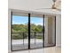 This condo features a delightful balcony with black metal railings overlooking a scenic, tree-lined lake at 100 Oakmont Ln # 305, Belleair, FL 33756