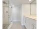 Bathroom featuring a glass-enclosed shower, sleek fixtures, and a vanity with marble countertop at 100 Oakmont Ln # 305, Belleair, FL 33756