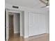 Bedroom with folding doors leading to closet storage at 100 Oakmont Ln # 305, Belleair, FL 33756