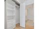 White closet with built-in shelving and drawers, offering ample storage space and organization at 100 Oakmont Ln # 305, Belleair, FL 33756