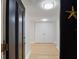 Bright condo entryway featuring wood floors and double door closet at 100 Oakmont Ln # 305, Belleair, FL 33756