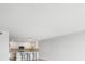 Open-concept living area with modern kitchen featuring a breakfast bar with seating, updated appliances and wood flooring at 100 Oakmont Ln # 305, Belleair, FL 33756