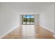 Bright living room space with wood floors and water view at 100 Oakmont Ln # 305, Belleair, FL 33756