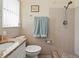 Bathroom with a shower featuring neutral ceramic tiling and a granite countertop at 10415 124Th Ter, Largo, FL 33773