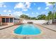 Inviting backyard pool with brick patio, lounge chair, dining table, and privacy fence at 10415 124Th Ter, Largo, FL 33773