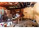 A basement shows wood beams, a table, trash, and miscellaneous items at 10854 Telford St, New Port Richey, FL 34654