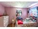 View of pink bedroom with window at 10854 Telford St, New Port Richey, FL 34654