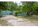 Single story home featuring a large yard with mature trees, showcasing its potential for outdoor enjoyment at 10854 Telford St, New Port Richey, FL 34654